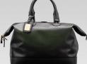 古馳-1921 collection- 深綠色真皮手提旅行包，配鑰匙扣和帶“G.Gucci Firenze 1921”草體字金屬牌的標識牌
